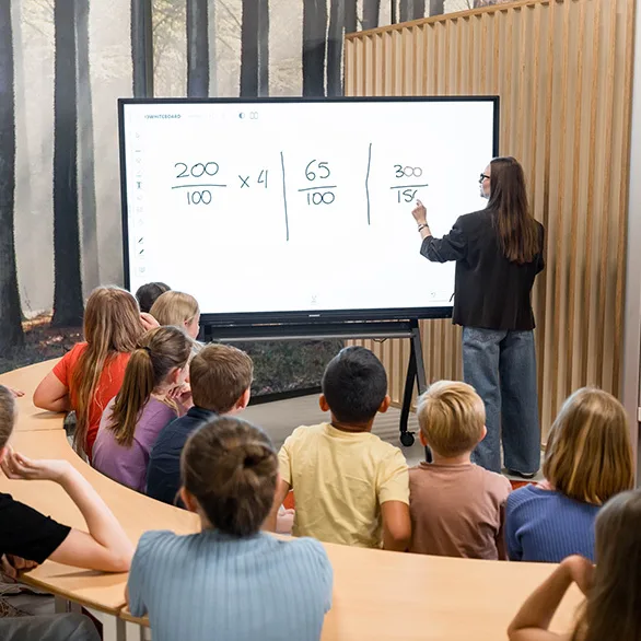Teacher writing math equations on i3CONNECT interactive flat panel